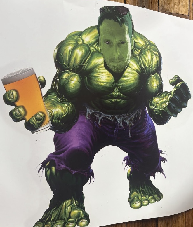 The Hulk mascot cut-out in the office, holding a well-earned beer