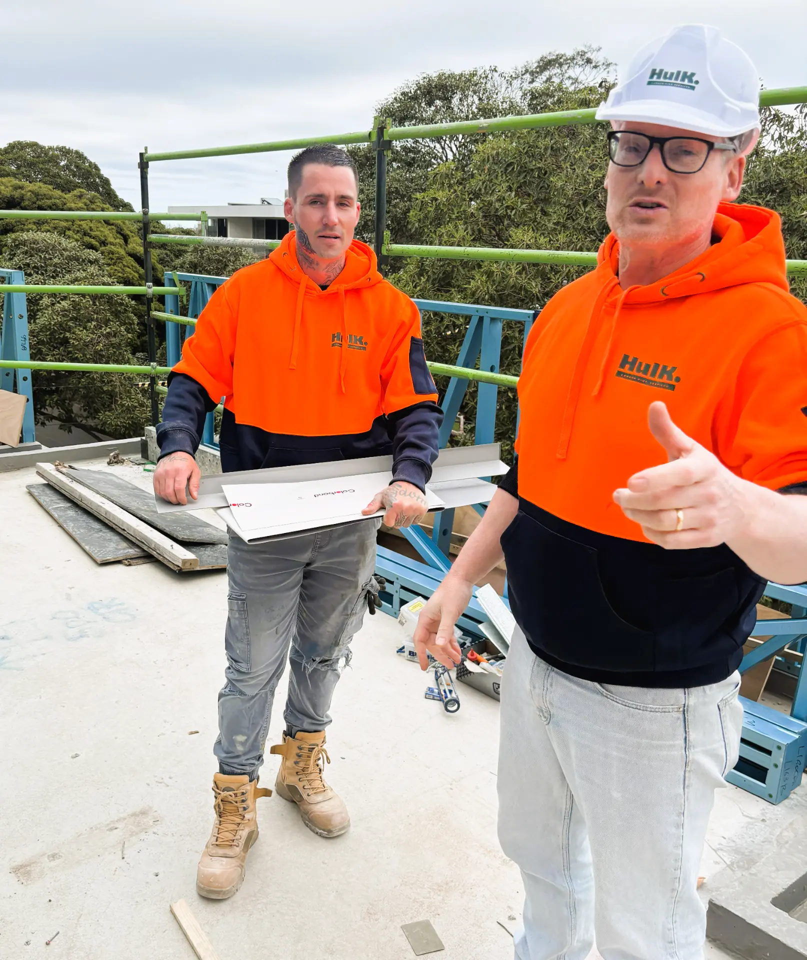 Hulk Director Tim working alongside a tradesman on an active construction site